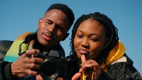Young Couple Discussing Photography in Natural Daylight