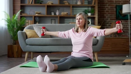 Senior Woman Working out with Dumbbells