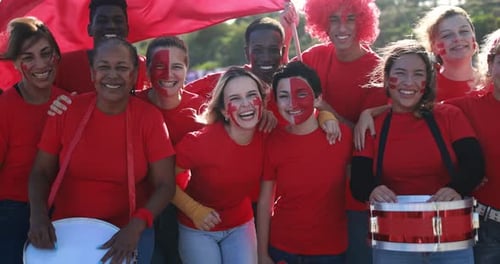 Enthusiastic Group of People Wearing Red Shirts Smiling