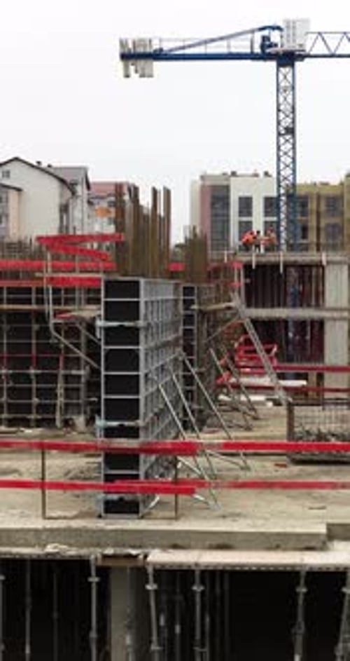 Vertical Aerial Drone Side Movement Revealing Reinforced Concrete Construction Site With Workers and
