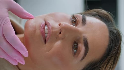 Beautician Checking Skin Woman in Clinic Vertically Closeup Facial Examining