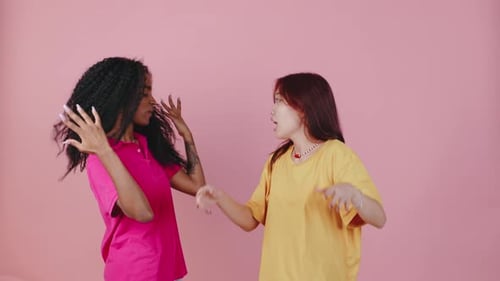 Two Young Women Dancing Together Happily in Studio