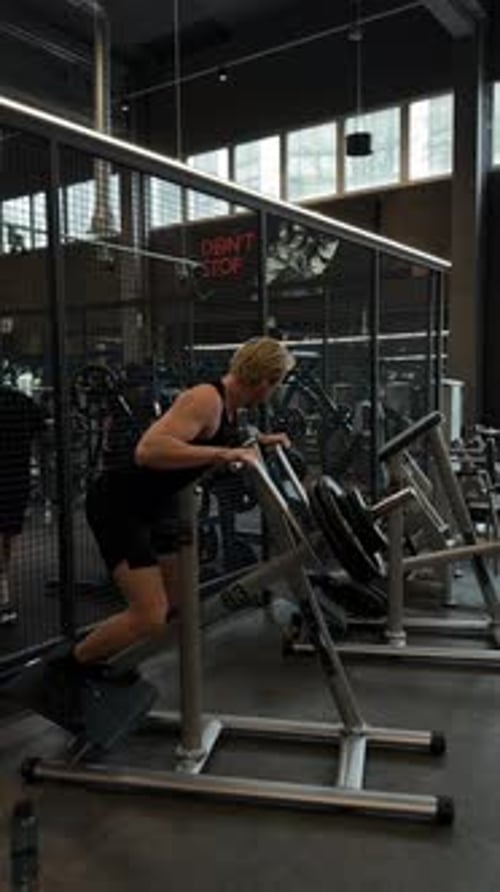 Focused Individual Performing Leg Exercises in a WellEquipped Gym