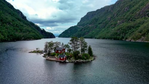 Explore a Serene Red Cabin on a Tranquil Island Surrounded By Lush Mountains in Norway