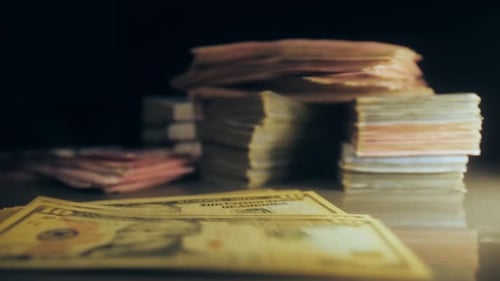Amerikanische Dollar-Banknoten, die auf den Tisch fallen, Nahaufnahme von Hintergrundbündeln von Bankgeld