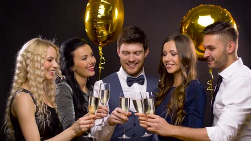 Smiling Friends Toasting Champagne at Party Celebration