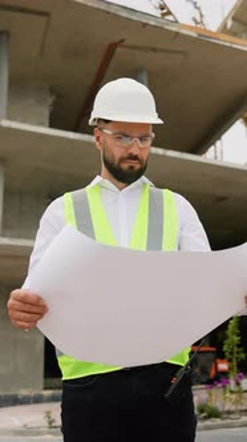 Civil Engineer Architect Examining Construction Blueprint