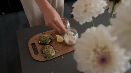 Woman Prepares Healthy Avocado Toast with Seeds