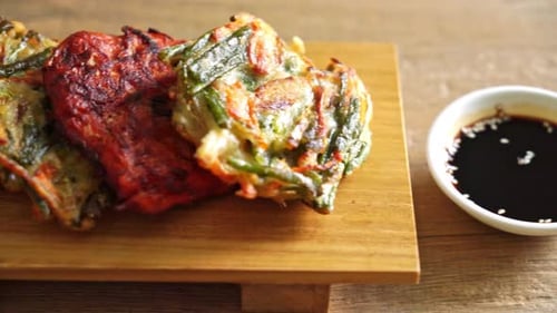 Korean Vegetable Pancakes with Dipping Sauce on Cutting Board