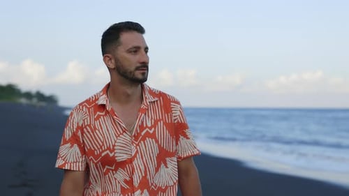 Alone Handsome Tourist Enjoys a Leisurely Walk By the Seashore Relishing the Serenity of the Ocean