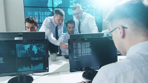 Team IT Security Professional Working in Bright Monitoring Room Filled with Displays