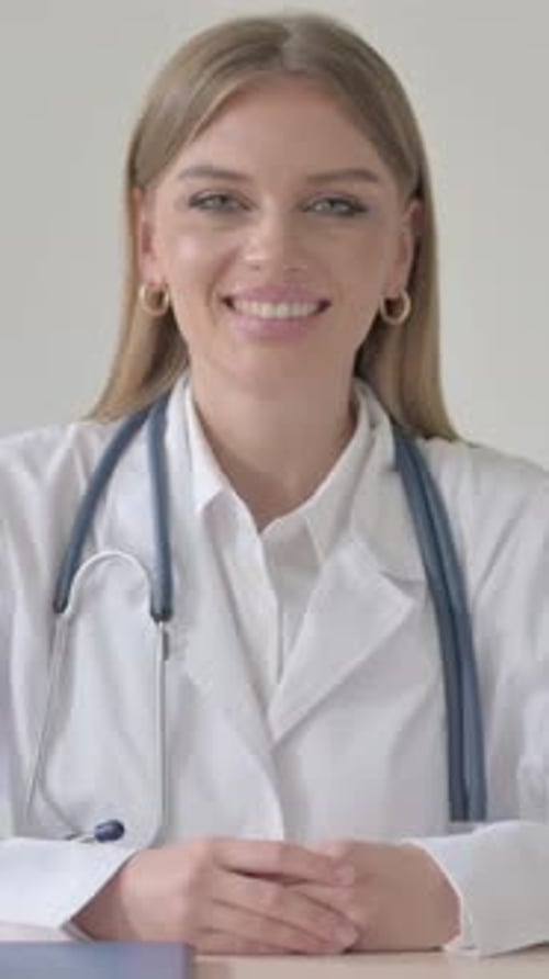Portrait of Female Doctor Smiling at Camera, Vertical Video