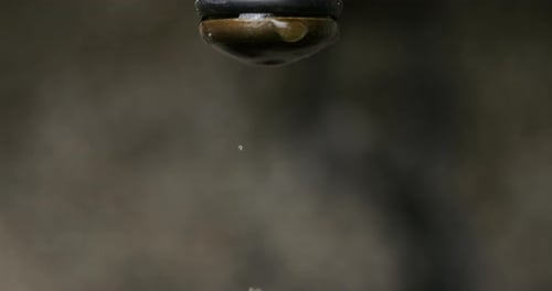 Water Droplets Fall From a Faucet