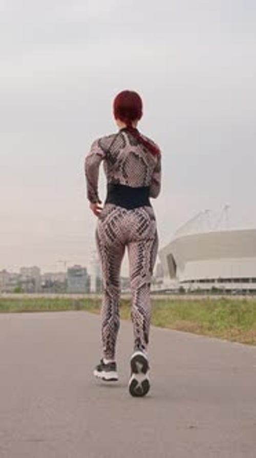 Slim Athletic Woman with Red Hair Run Girl Athlete is Engaged in Jogging