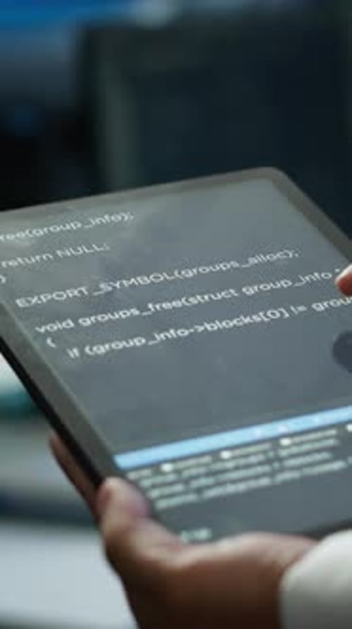 Vertical Video Close Up of Tablet Used By IT Worker Doing Maintenance on Server Farm Gear