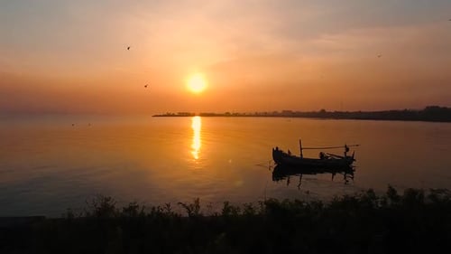 One Boat At The Sunset With Cinematic Aerial View