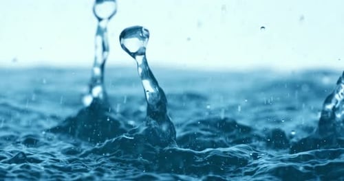 Rain water drops falling in super slow motion.