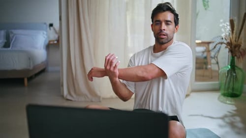 Man Takes Online Fitness Class at Home
