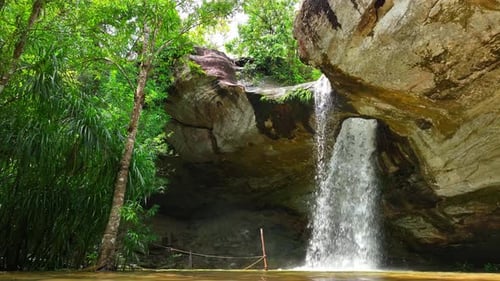 Tropical Waterfall Flowing Through Lush Green Nature