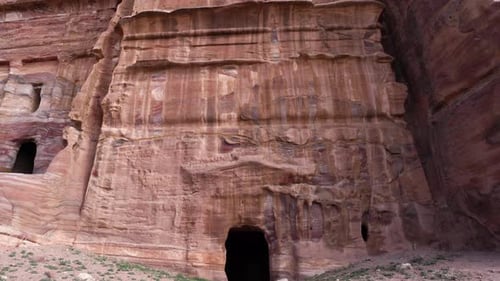 A Reveal Shot of Tall Ancient Temple Facade Carved Out of the Sandstone in Ancient City of Petra
