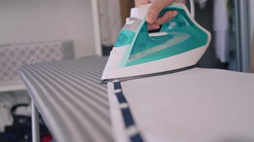 Close Up Ironing Clothes on Ironing Board