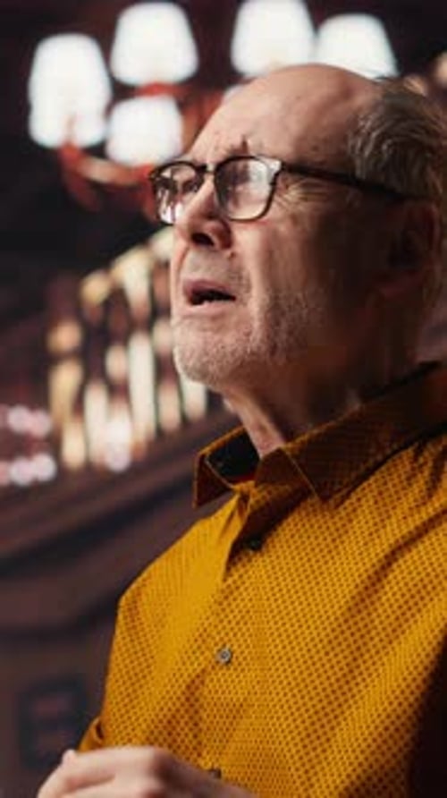 Mature Man Speaking and Gesturing Indoors