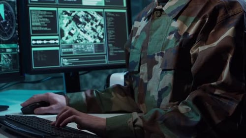 Military Soldier Operating Advanced Technology in a Command Center