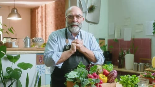 Senior Food Blogger Describing Fresh Vegetables on Camera in Kitchen