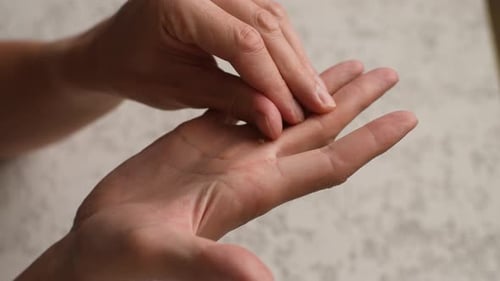 Closeup Cropped Shot of Unrecognizable Young Man Scratching and Tearing Off Callus on Palm of Hand