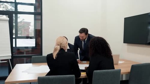 Team of Adults Work Together in an Office