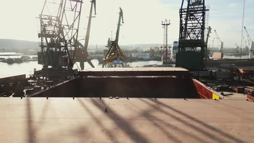 Aerial View of Big Cargo Ship Bulk Carrier is Loaded with Grain of Wheat in Port at Sunset