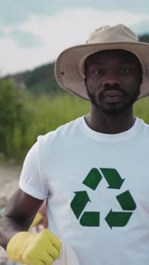 Person Holding Trash Bag for Recycling Outdoors