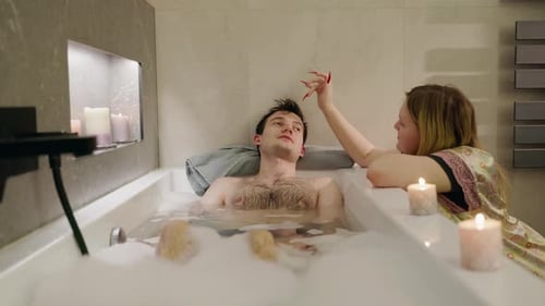 Couple Relaxing in a Bubble Bath Together