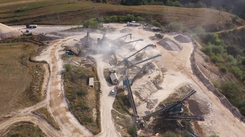 Aerial view of stone quarry conveyor belt system in operation, stone jaw crusher plant