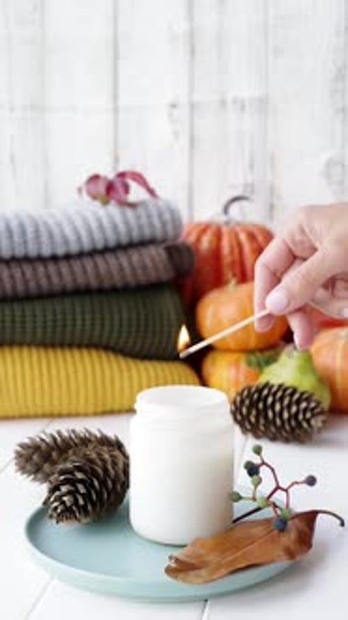 High angle view autumn composition with sweaters and candles, white candle mockup design