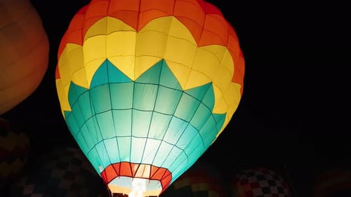 Illuminated Hot Air Balloons at Night being Inflated