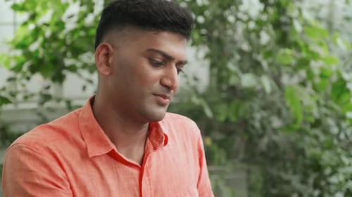 Man Discussing Business Paper with Colleague in Cafe