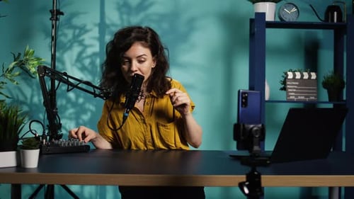 Content Creator Using Smartphone to Film ASMR Video Tapping on Mic