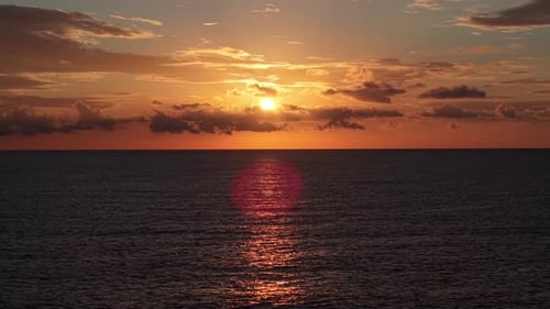 Bright Sunrise Over the Calm Mediterranean Sea Near Altea Spain with Golden Sunlight Reflecting on