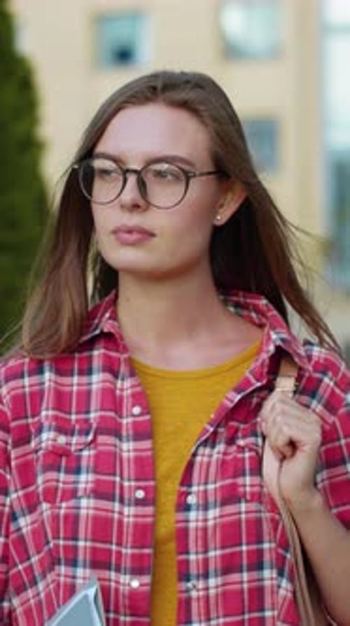 Smart Student Successful Young Woman Wearing Glasses and Bag Looking at Camera Standing on Street