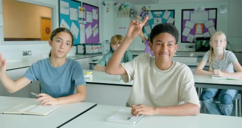 School Children in Classroom Raising hand to Ask question to the Teacher