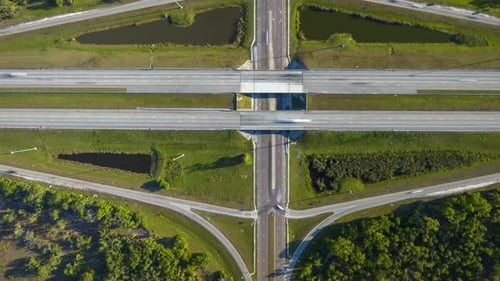 Timelapse of Freeway Exit Junction Over Road Lanes with Fast Moving Traffic Cars and Trucks
