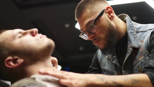 Barber Giving a Client a Neck Shave