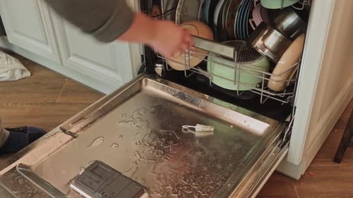 Dishwasher loading process in a modern kitchen