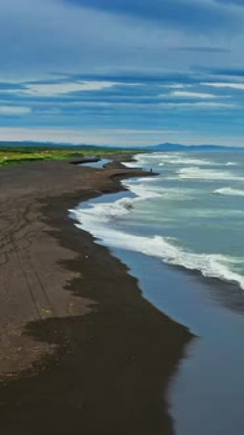 Beach with black sand and volcano