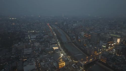Aerial Panoramic View of Evening City Cars Driving on Busy Road Leading Along River Illuminated