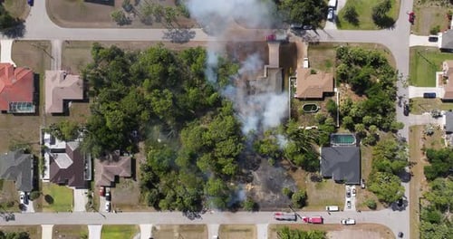 Vegetation Fire Spreads Near Florida Residential Area As Firefighters and Fire Trucks Race to