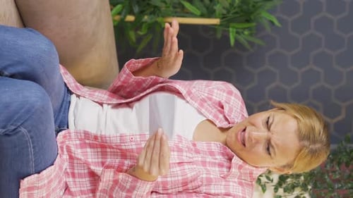 Woman Reacts Negatively to Document on Couch