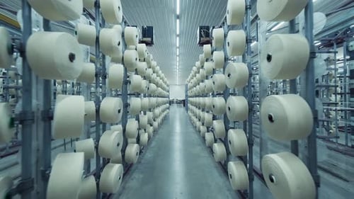 Modern Textile Factory with Rows of White Yarn