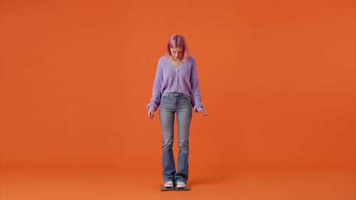 Disappointed Woman Standing on Electric Scale in Studio